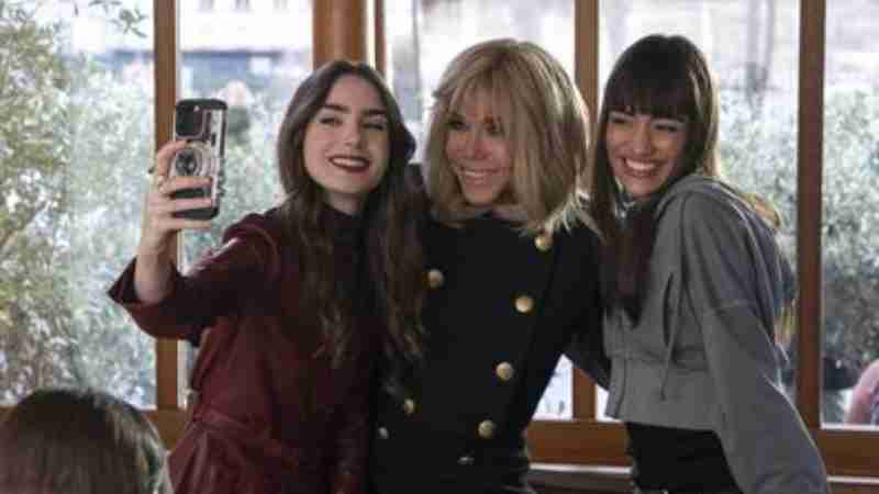 Lily Collins (left) French President Emmanuel Macron's wife Brigitte Macron (centre) and Thalia Besson (right) pose for a selfie during the shooting of episode 407 of Netflix series "Emily in Paris" on April 2, 2024, tags: emily di - Stephanie Branchu/Netflix